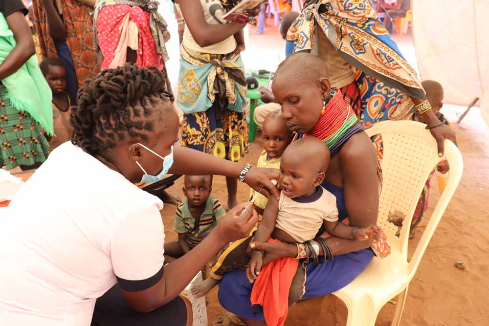 A child gets vaccinated during a nine day Kimormor outreach in Loima Sub-county,Turkana-Kenya .The outreach targeted pastoralism returnees from Uganda who had missed out on the key services. Credit: County Government of Turkana.