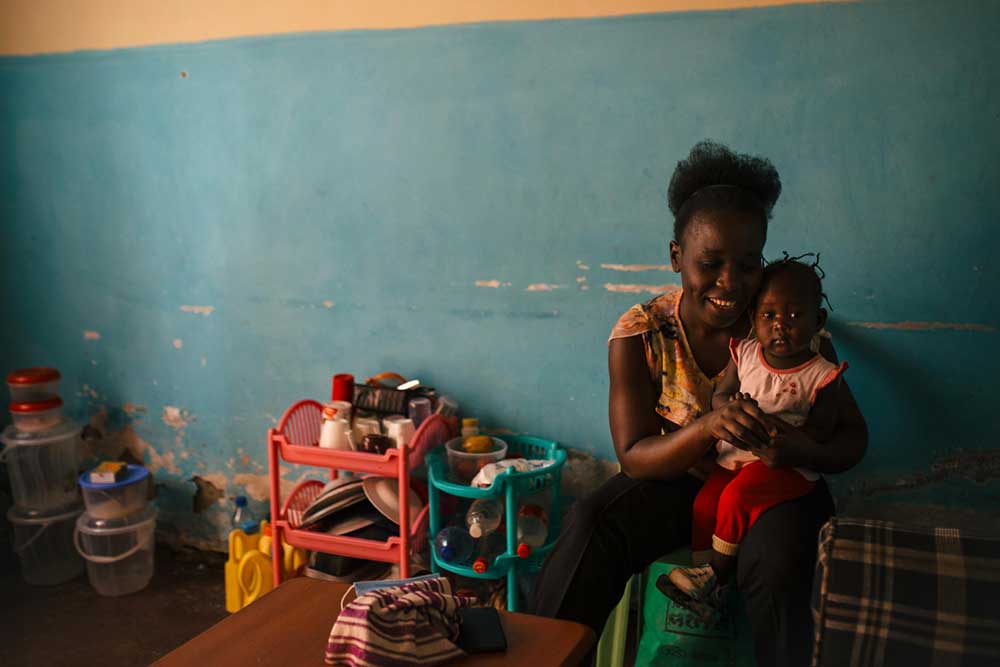 Faith Walucho with her then-13-month-old daughter, Nia, in their home in Nyalenda slums. Credit: Kang-Chun Cheng