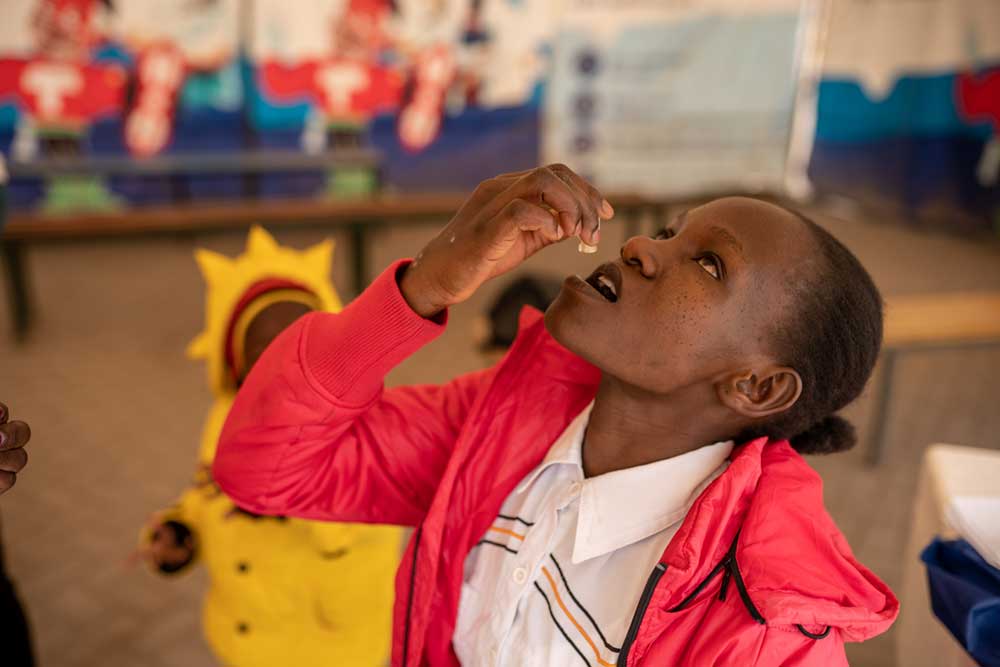 Janet Maloba, 27, swallows a dose of the Oral Cholera Vaccine at a vaccination Facility inside Kitengela Sub County Hospital. Credit: Kelvin Juma