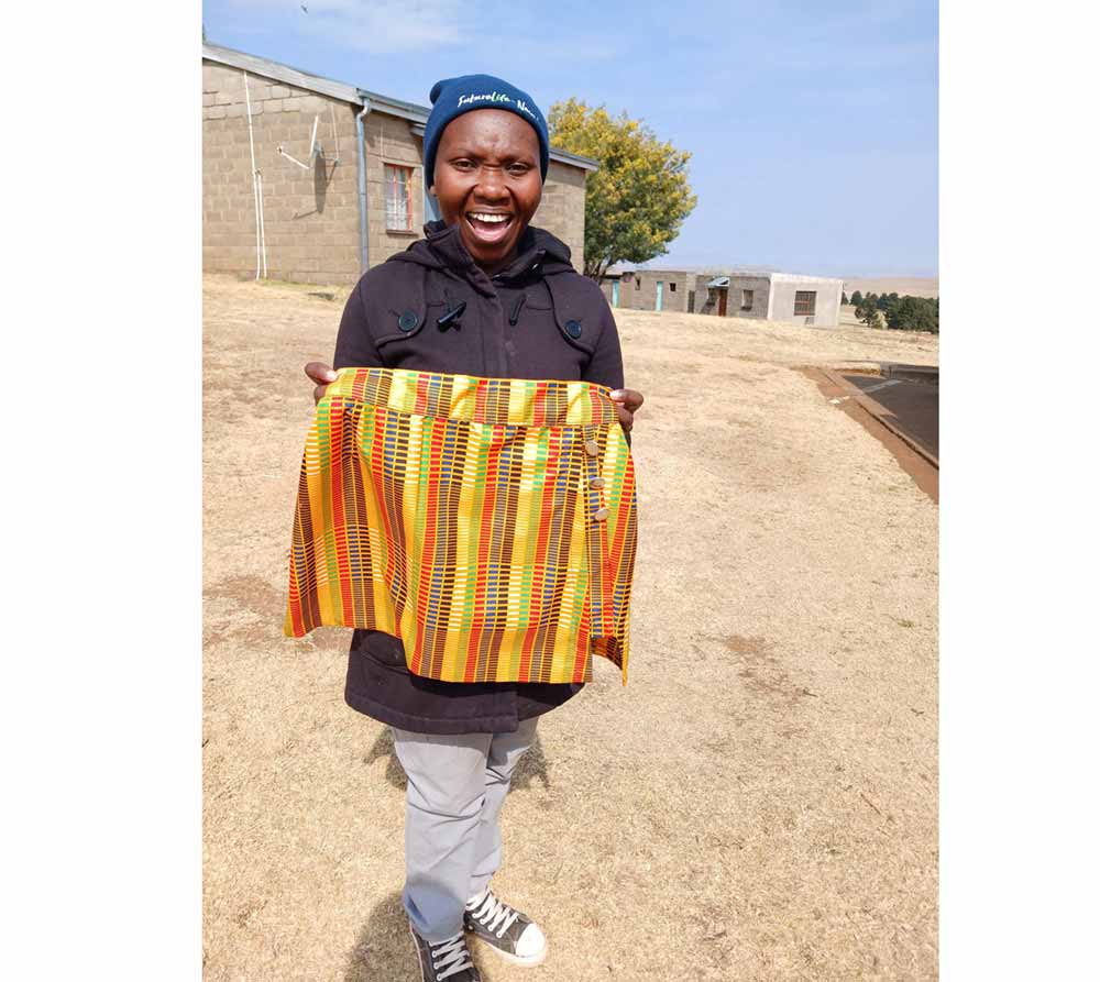 Young mother Keneuoe Ramohanoe, currently studying fashion design at Shepherd Centre for Teenage Mothers, proudly showcases a skirt she made. Credit Pascalinah Kabi