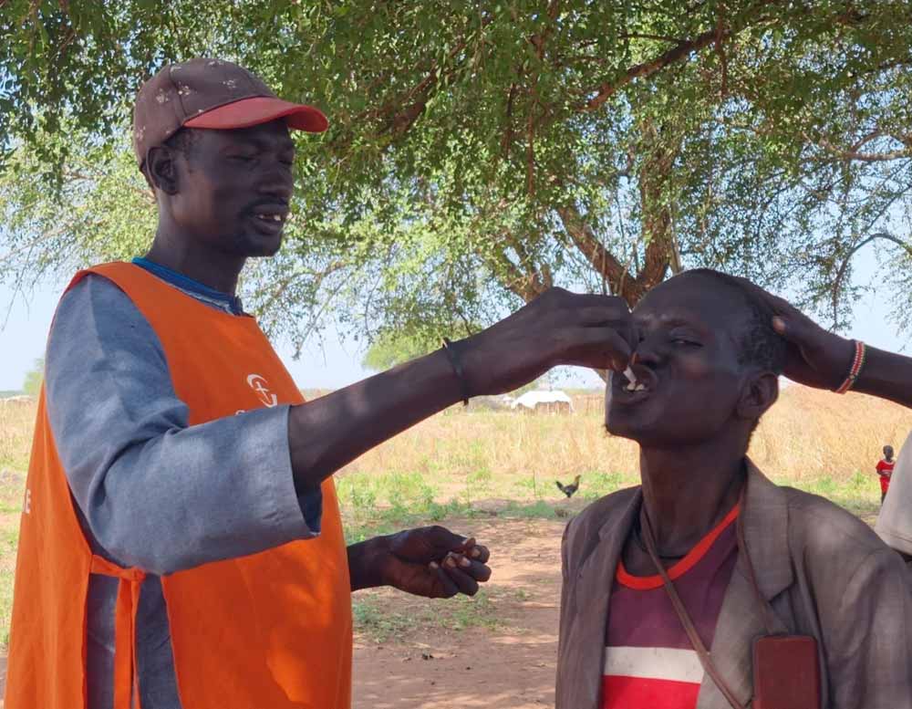 A vaccinator giving Mawun Aboi the cholera vaccine. Credit: Winnie Cirino
