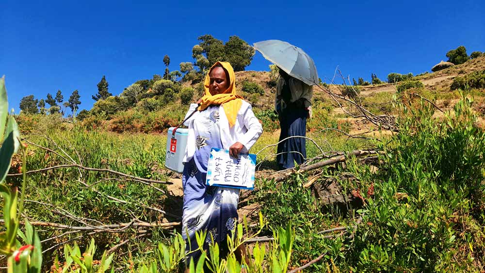 As Meseret arrives in the village she meets the first mother to bring her son for vaccinations. Credit: Solomin Yimer