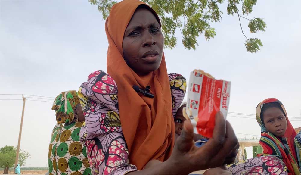 Rashida displays a sachet of RUTF given to her daughters. Credit: Zubaida B Ibrahim