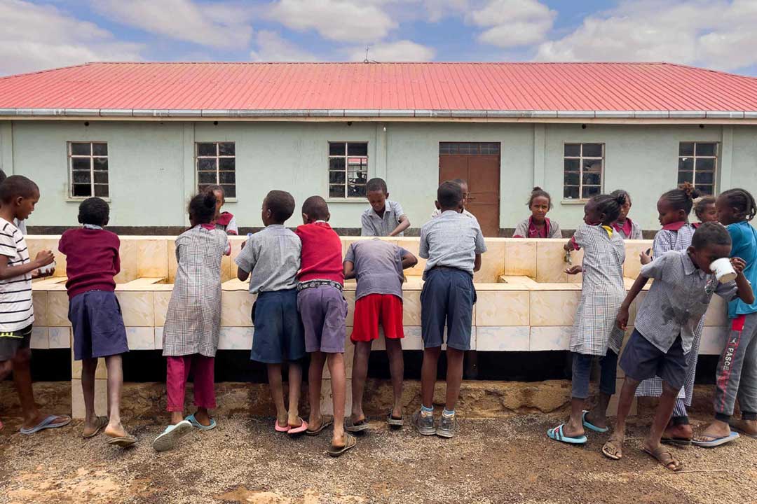 Students wash and drink outside the Tigo boarding school. Credit: Larry C. Price
