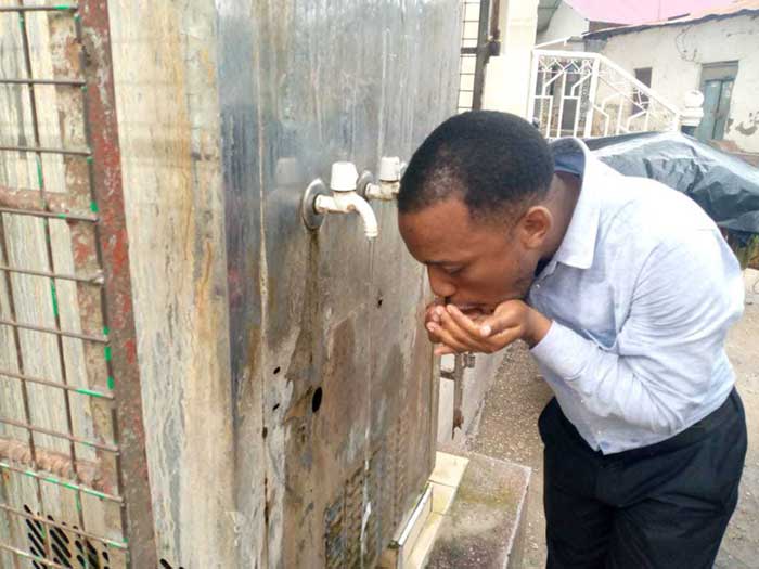 A resident of Rahaleo in Zanzibar drinks water directly from the tap.