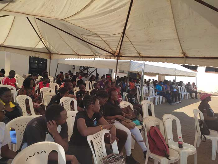 Young girls and their parents listen to speeches during the cervical cancer vaccine campaign in Western Kenya. Credit: Angeline Anyango