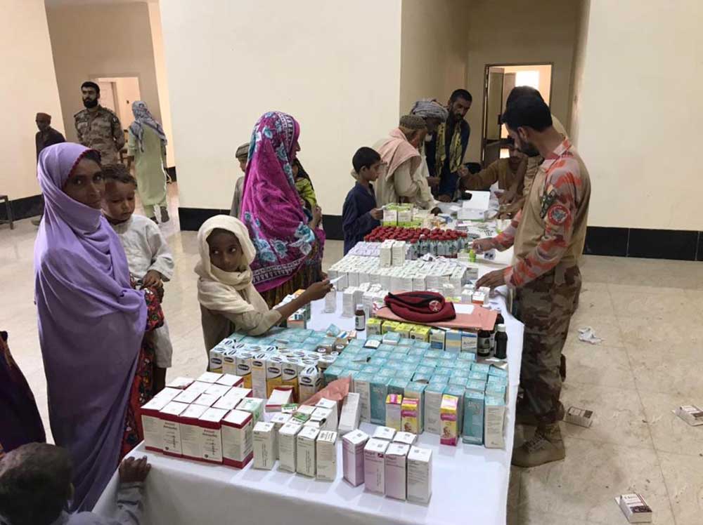 Women and children receiving free medicine from a health camp. Credit: Ministry of National Health Services and National Disaster Management Authority
