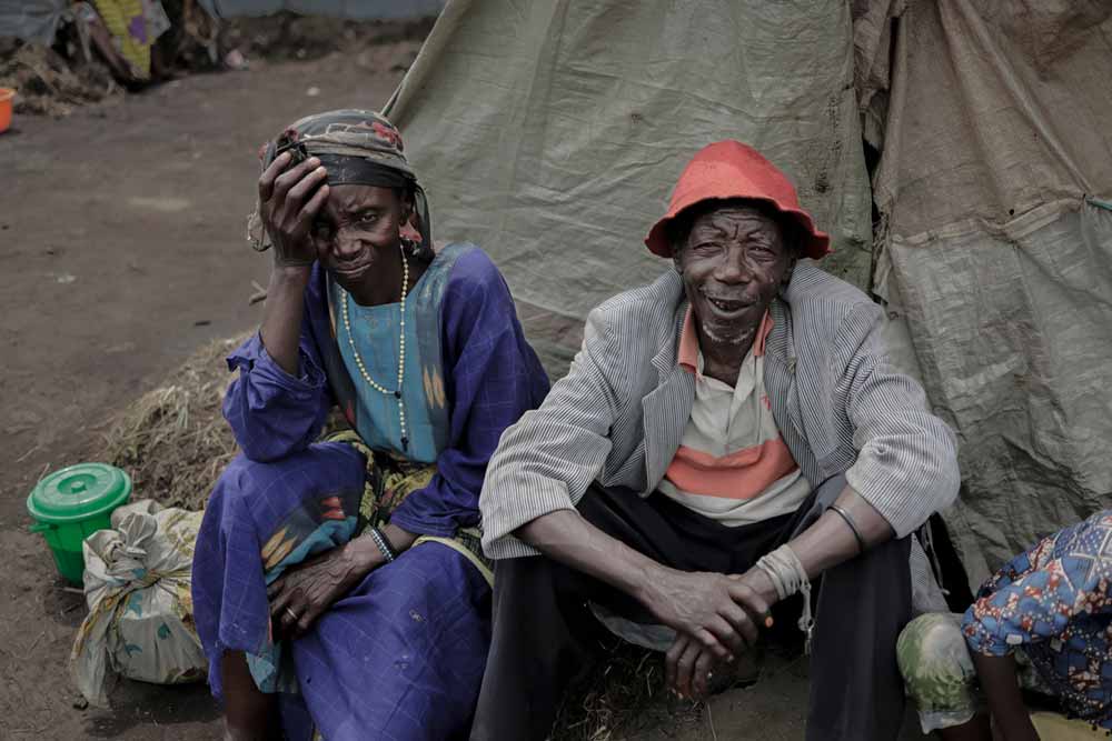 Jean-Marie, 71, sits with his family in front of their shelter; they fled their home to Bulengo camp in February. He worries that the camp situations are worsening. “Things don’t change. People want to get back to where they came from. Their village. Their town.” Photo: WHO / Guerchom Ndebo