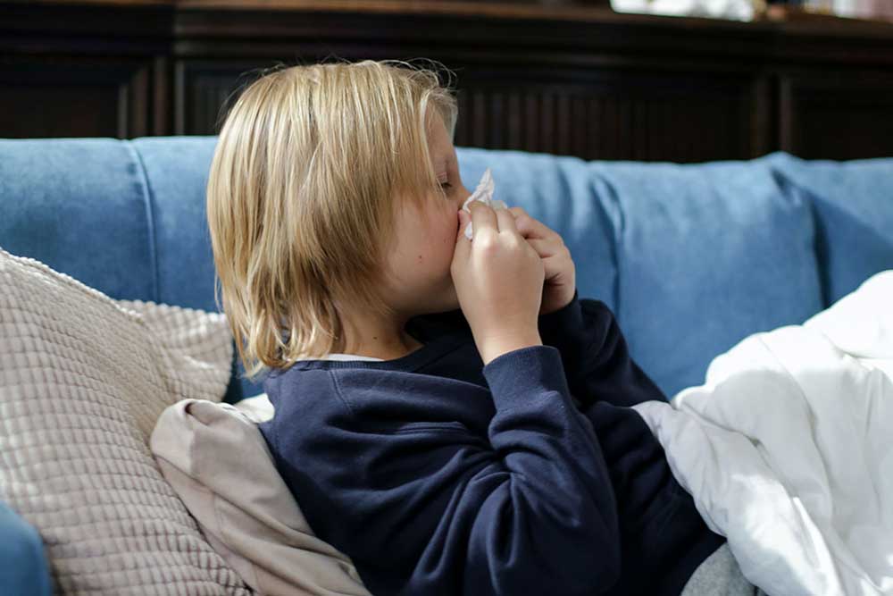 Child blowing their nose.