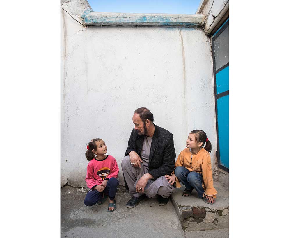 Shahwali, 53, with his daughters, Zahra and Zainab  Kabul, Afghanistan  Photographer: Oriane Zerah