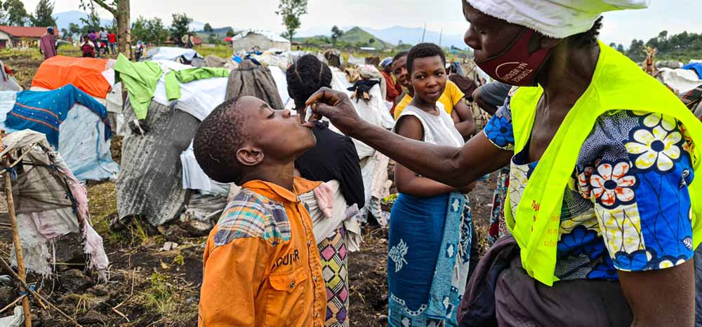 Delivering cholera vaccine to displaced persons camps in Democratic Republic of the Congo has been a pressing need. Here health care workers distribute oral cholera vaccinations at the Bulengo IDP site, near Goma, North Kivu. Photo: WHO / Eugene Kabambi