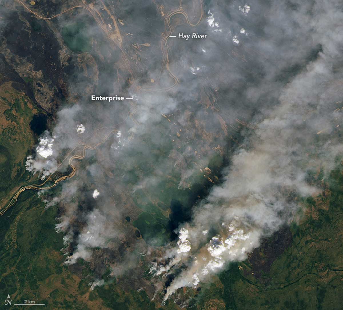 Smoke from wildfires in the Northwest Territories, in northern Canada, on August 16, 2023 captured on an image from Landsat 8. Nearly a quarter of a million people were evacuated during Canada’s 2023 fire season, including two-thirds of the population of the Northwest Territories. Image by Lauren Dauphin via Wikimedia Commons (Public domain).