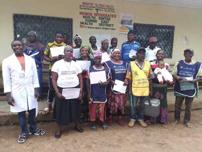 Sherika Joan (au centre, au premier rang) pose avec d’autres membres du personnel de santé avant de se lancer dans une campagne de vaccination de routine. Credit: Bernyuy Denis