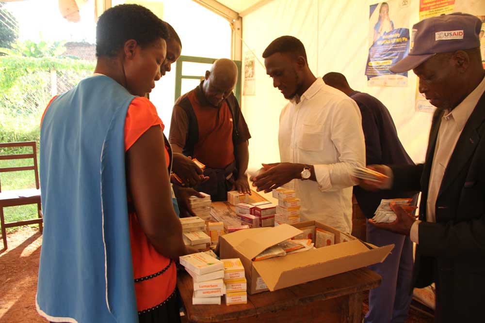 MobiKlinic's Pharmacist And Head Of Research hands out over the counter drugs and supplements to CHWs.
