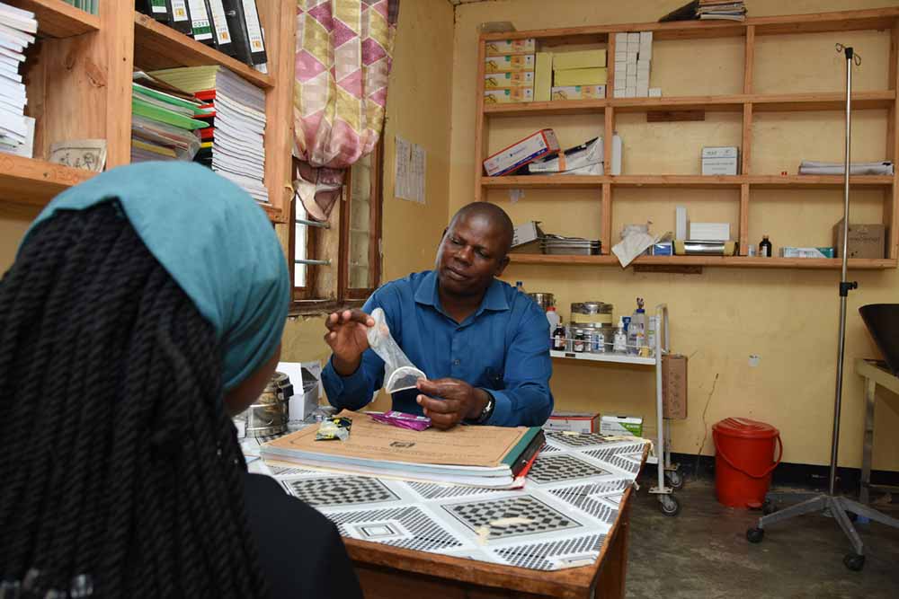 A healthcare worker attends to a young person seeking reproductive health services at Soya Health Centre's Youth Friendly Health Services Corner in Chemba District, Dodoma Tanzania. Photo by Benjamin Mkapa Foundation.