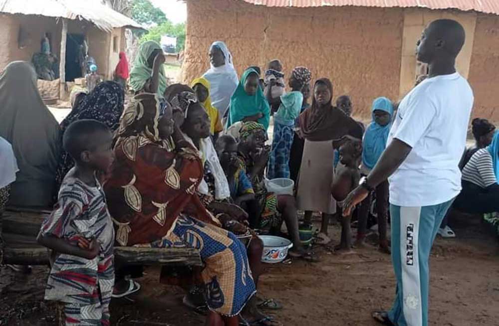 A volunteer addressing families about HPV dose in Moro. Credit, LEAH Foundation