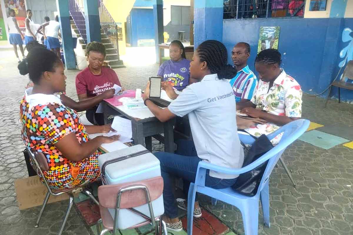 JSI and partners conduct joint monitoring to review the vaccination register in a school in Ashaiman district, Ghana. Credit: JSI