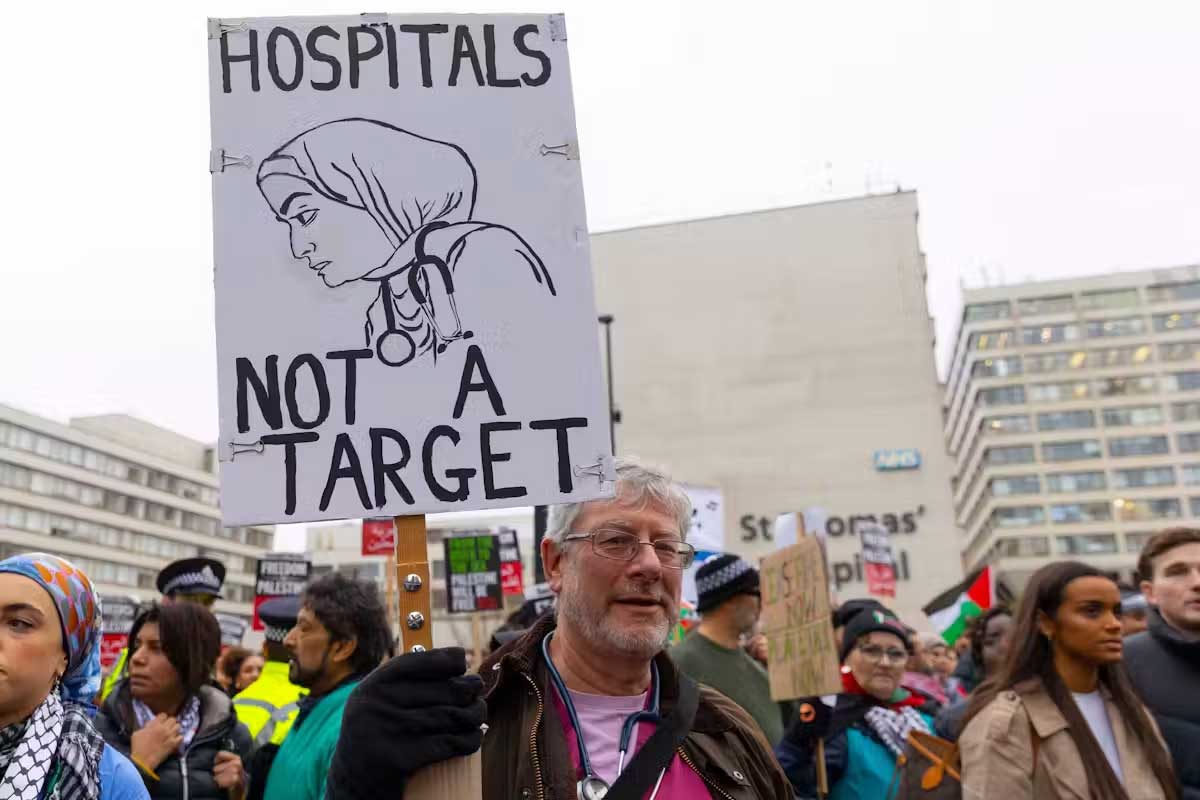 Health-care workers killed in Gaza were remembered at a London vigil, December 2023. Zeynep Demir Aslim/Shutterstock