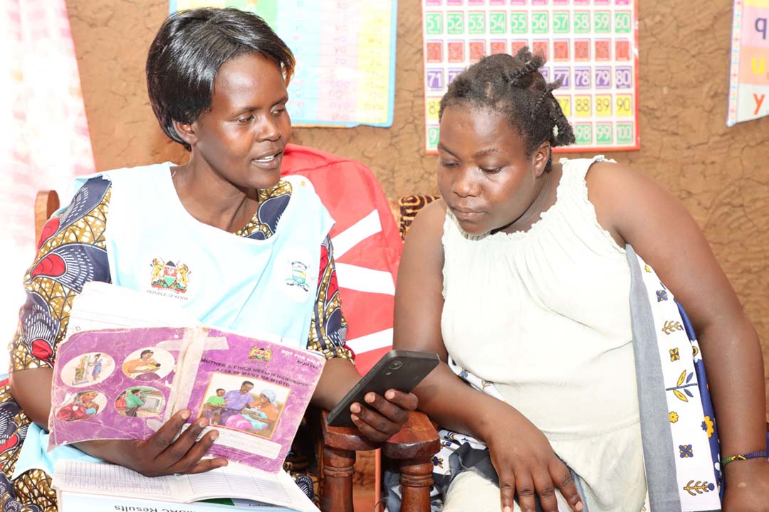 Jackline Vugutsa, a community health promoter, uses a mobile device to collect data during a household visit in Vihiga County, Kenya. Credit: PATH/Denise Akun.