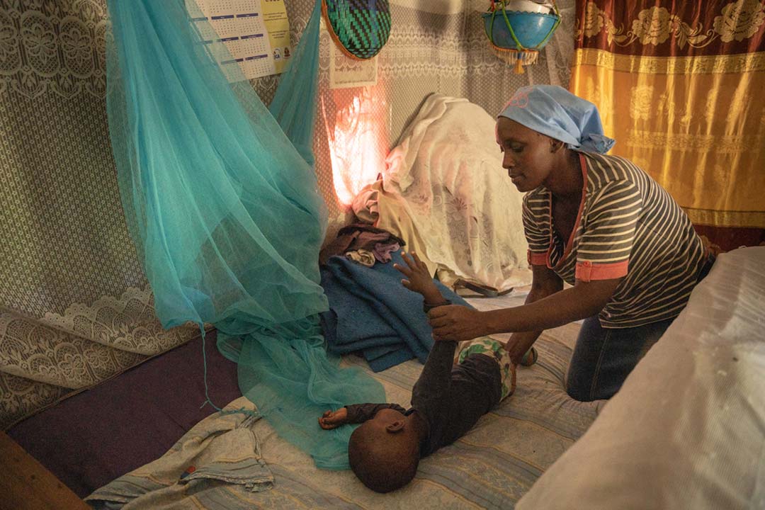 Mercy Shem, a mother of four living in the bushy village of Mukende now has an easy time with her youngest son, Amory Shem,because he has received the first dose of malaria vaccine. Kenya, 2023. Credit: Gavi/2023/Kelvin Juma