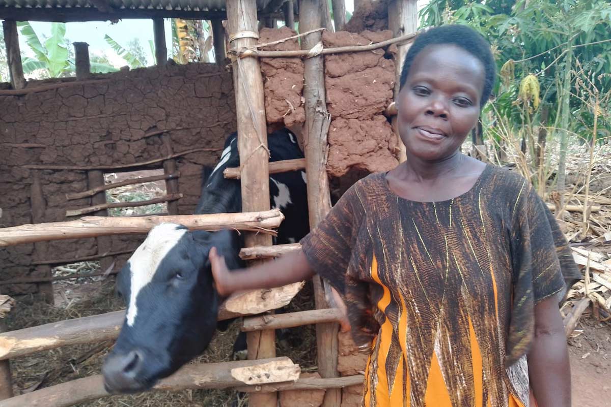 Nikuze poses for a picture with her cow. Credit: Hudson Kuteesa