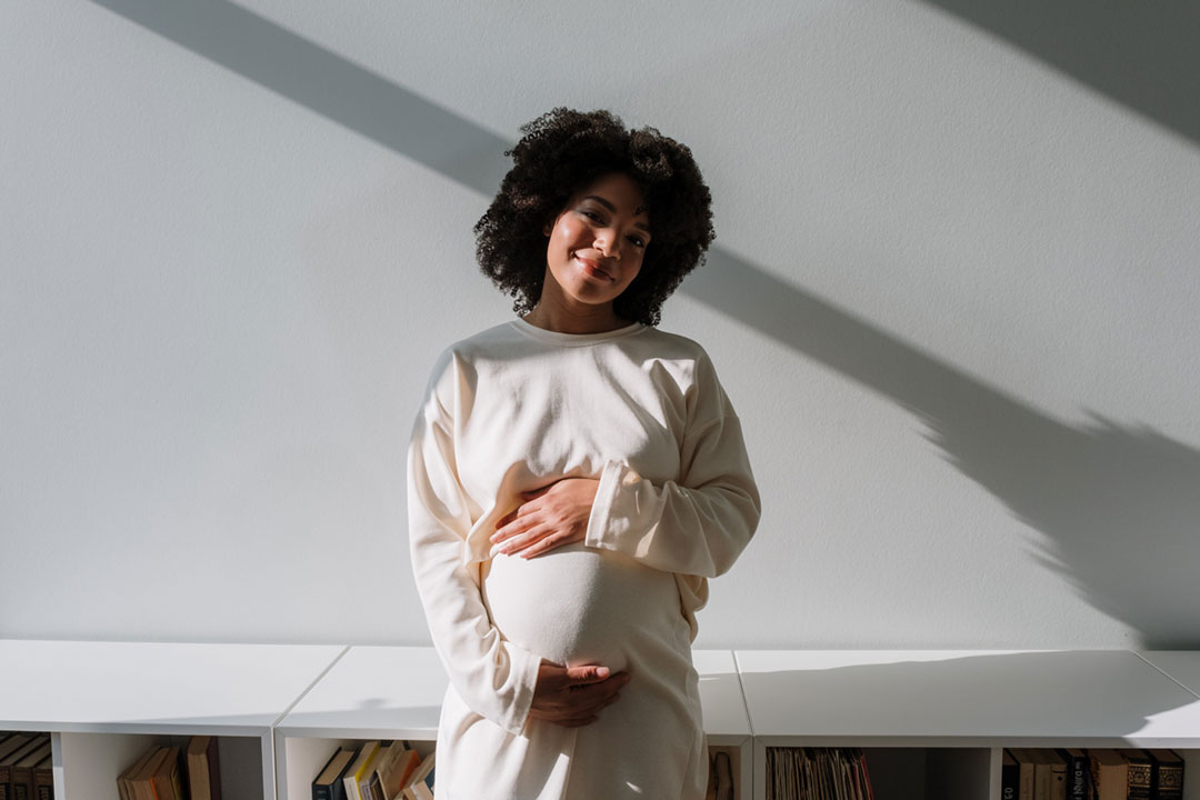 Pregnant woman holding her belly. Credit: cottonbro studio on Pexels