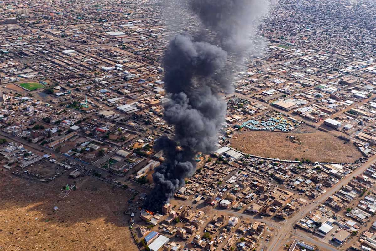 Smoke rises above a neighbourhood in the Sudanese city of Omdurman. Shutterstock/Abd Almohimen Sayed