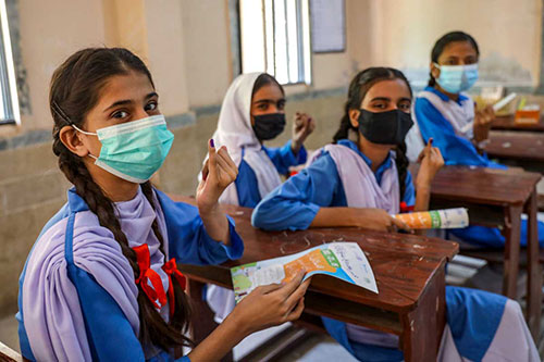 Adolescent girls proudly show the ink mark on the tip of their finger: proof that they have been vaccinated against measles and rubella during a nationwide campaign in Karachi, Sindh province, Pakistan. Credit: Gavi/2021/Asad Zaidi