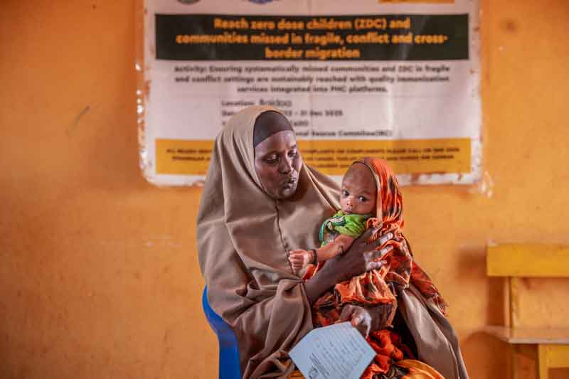 A mother holding her child after a vaccination session at an outreach vaccination facility, part of the Reach Zero Dose Children (ZDC) campaign in Somalia. Credit: Gavi/2024/Mohamed Abdihakim Ali