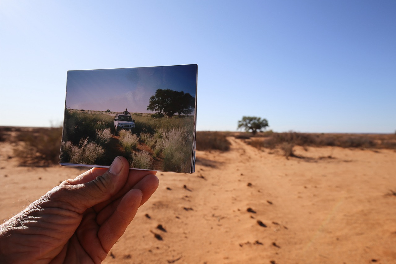 A farmer shows a photo of how his farmland looked before the onset of drought in the Northern Cape province of South Africa. As climate change rapidly alters and degrades Earth landscapes, people can be overwhelmed by a sense of loss and powerlessness. Image by Petro Kotze.