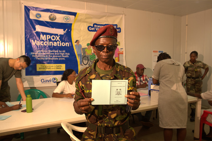 A security officer displays his mpox vaccination card at the 34 Military Hospital in Freetown. Photo credit: Saidu Bah.
