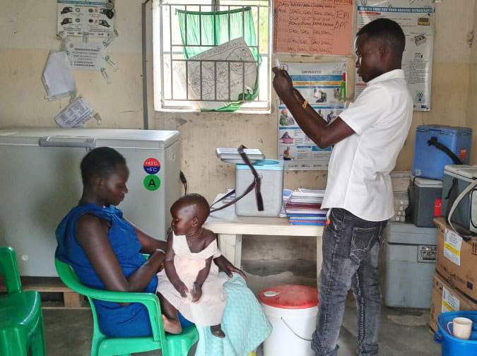 A vaccinator administering a vaccine to a baby at Omeo PHU. Credit: Winnie Cirino