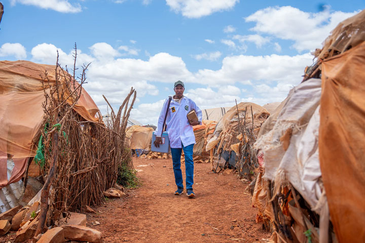 Adan Abdirahman Mohamed carries the cooler for vaccines as he leaves READO facility following a day of vaccinations in Baidoa, Somalia