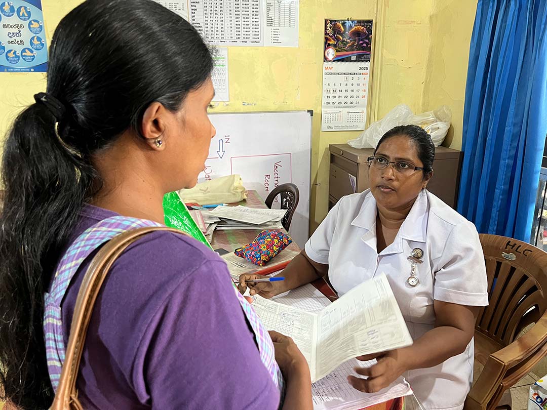 Chief Midwife W. A. M. M. Weerasekara with a mother at the Divisional Hospital Thalangama Credit: Aanya Wipulasena