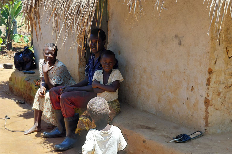 Gloria Eyotaru, a mother in Ewavu village Ezuku parish in Arua district, seated with her husband and children. Credit: John Mesenze