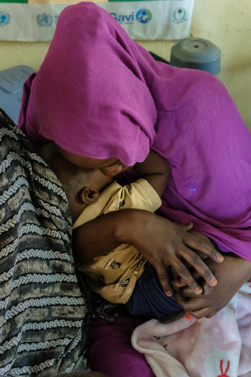 A mother hugs her child to relieve the pain of the vaccine injection. Umm Al-Khair, Sudan. March 5, 2025.