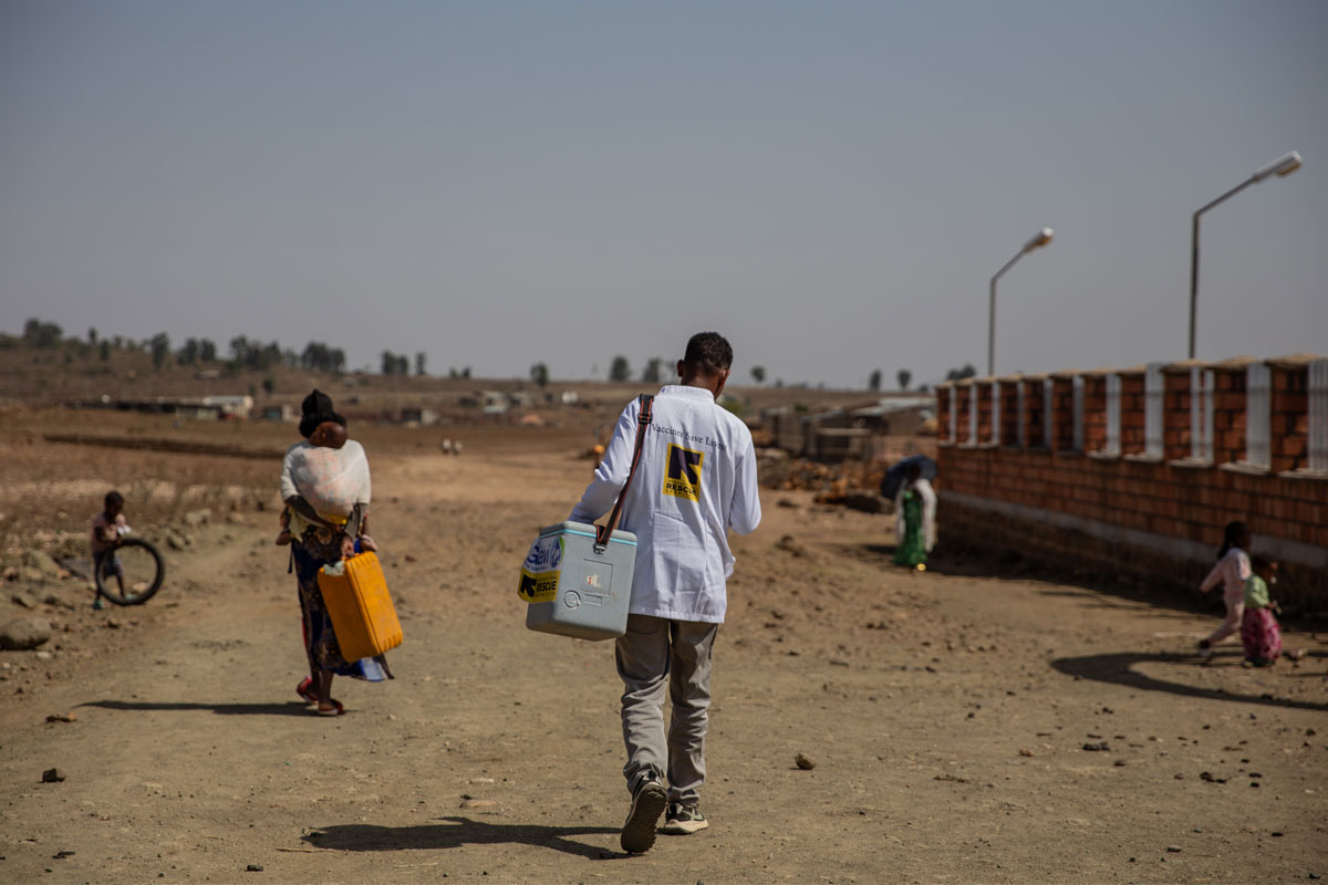 23 June 2025 – Tigray, Ethiopia. Adiet Semema Primary Hospital. Mebratu Gebreselassie, and an EPI expert, during his outreach session. He travels to surrounding communities for outreach 5–6 times a month. Of the 40 children he vaccinates on average, he estimates that nearly 20 are zero-dose children and 5–7 are under-immunised. Credit: Martha Tedesse/IRC