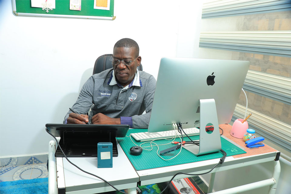 Medical illustrator Ben Nyangoma at his desk in Nairobi. Credit: Pauline Achieng Tom