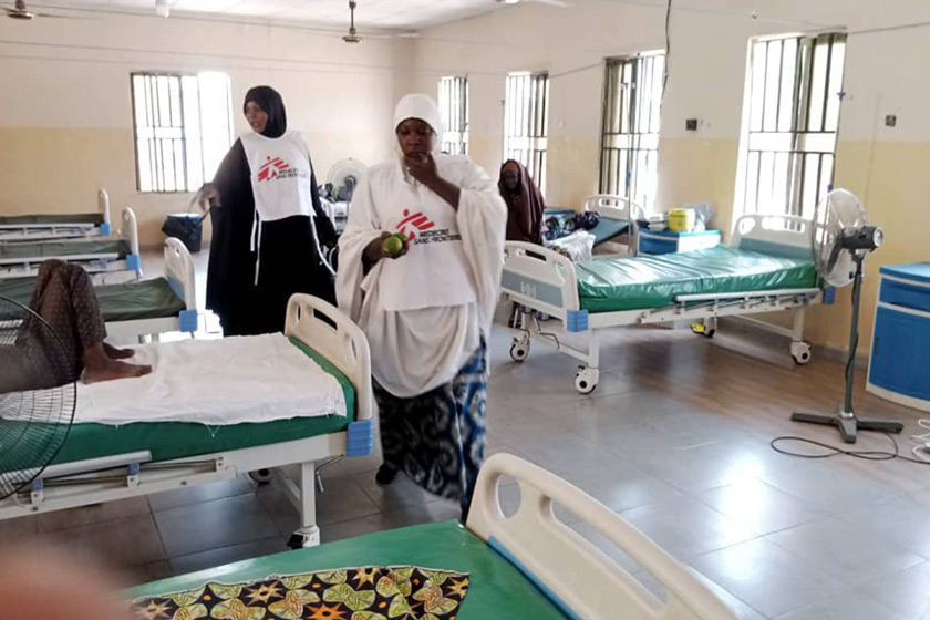 Health workers with Medicine Sans Frontier check on patients inside one of the isolation wards