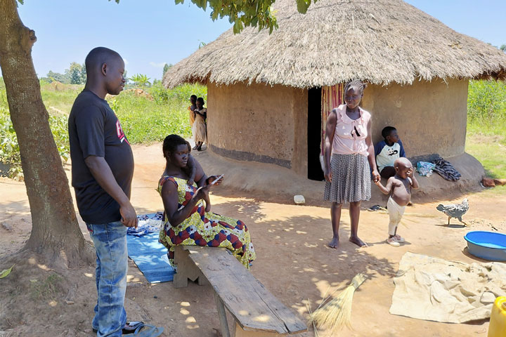 Monica Dawaru with her spouse and family at their home stead in Ocevu village, one of the hard to reach ares in Arua district