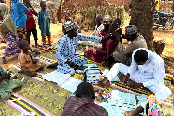 Murtala Aliyu (village head) holding his last son to be vaccinated at the CHAN REACH vaccination site in Tung settlement, Wurno LGA, Plateau State, which was held in September 2025. Credit: Maureen Onah