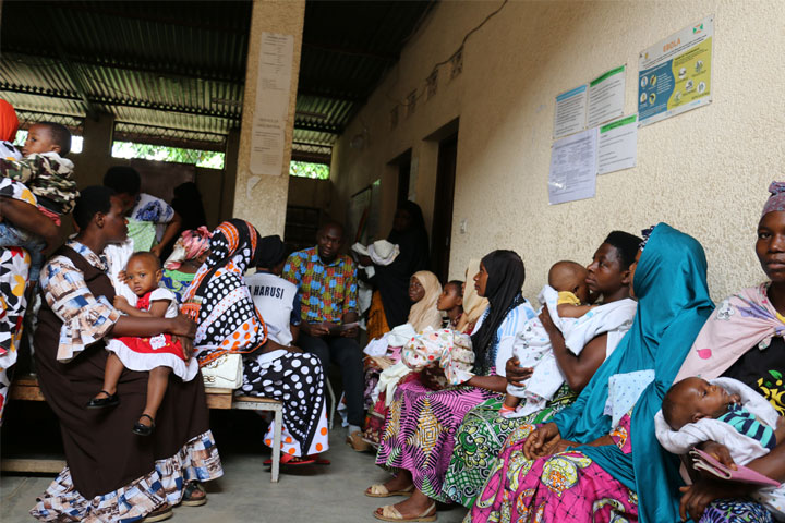 Nyamundende Assumani reaching out to parents about the routine vaccination. Credit: Moses Havyarimana