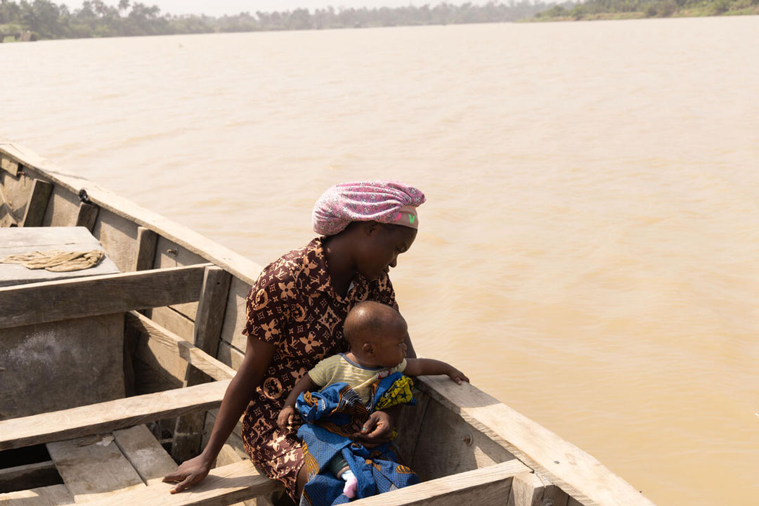 Permanent, 23, and her son Talent, on the river in the Onuegbu community. Ogbia, Nigeria. December 19, 2024. Credit: Jérôme Sessini