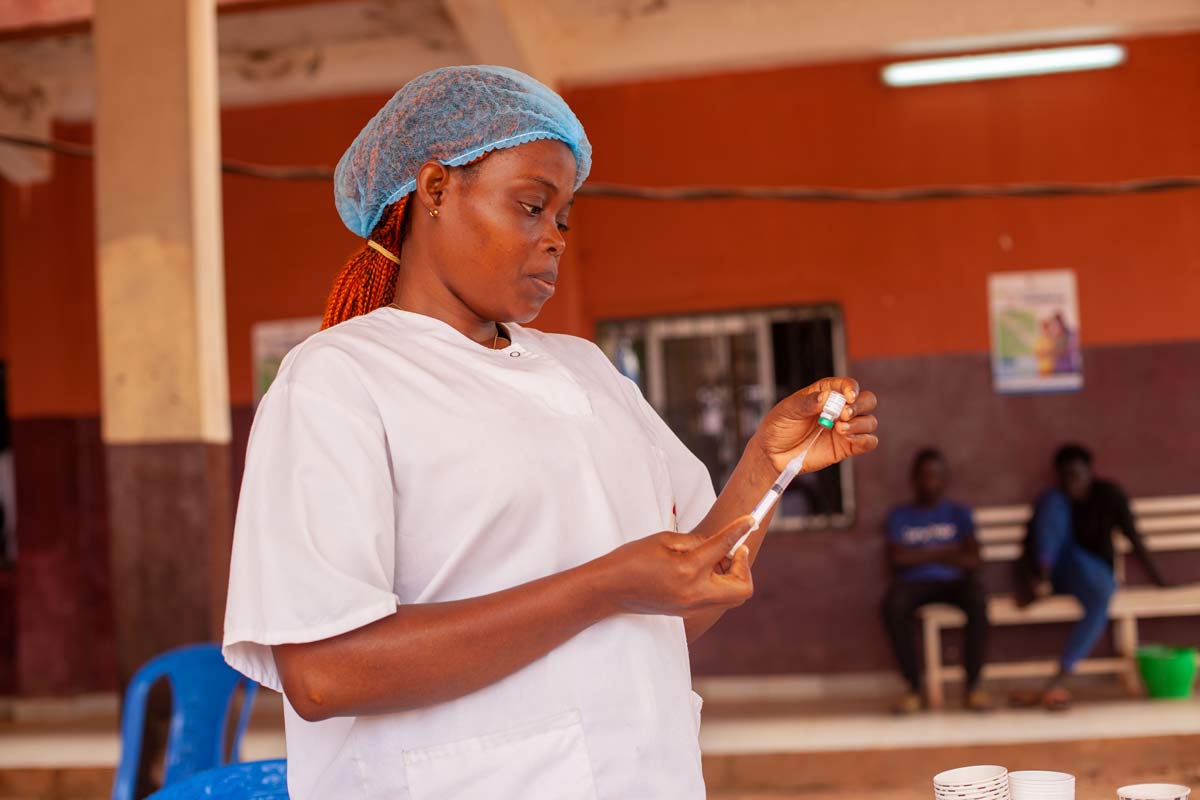A health worker prepares a shot of the malaria vaccine during the introduction in Cameroon. Credit: Gavi/2024/Go'tham Industry