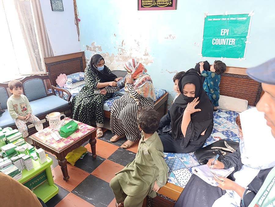 Women and children receiving healthcare at a Clinics on Wheels camp. Credit: Rahul Basharat Rajput