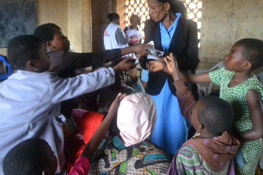 A nurse with girls at a school in Malawi before they receive the HPV vaccines