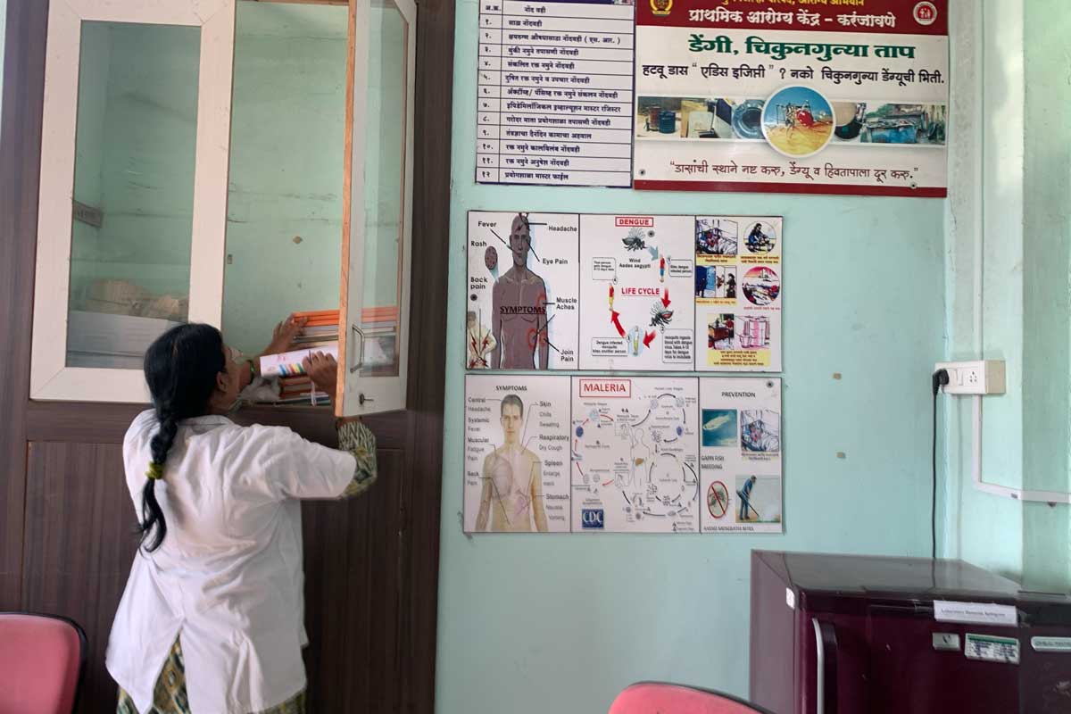 Bharti Mali, Laboratory Scientific Officer with dengue posters in the background. Credit: Sweta Daga