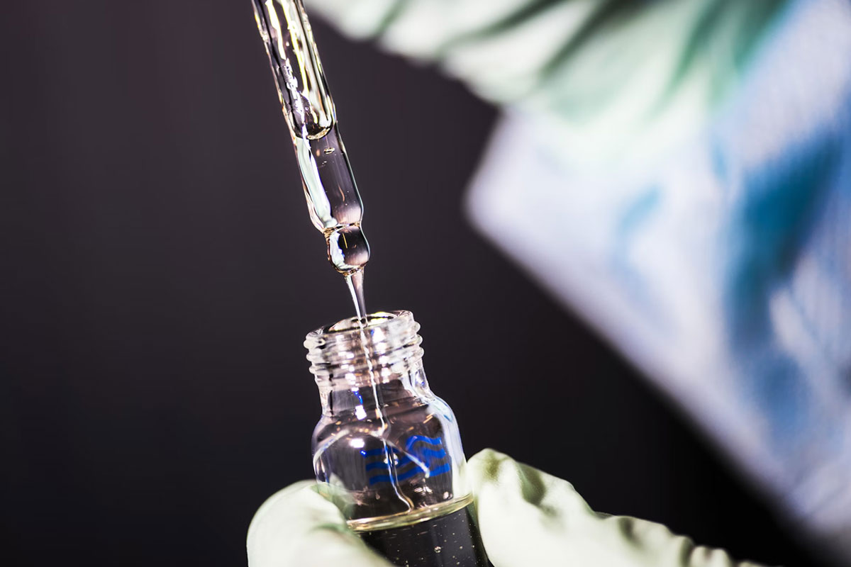 aboratory technician in the process of pipetting a sample from a vial. Credit: The Centers for Disease Control and Prevention (CDC)