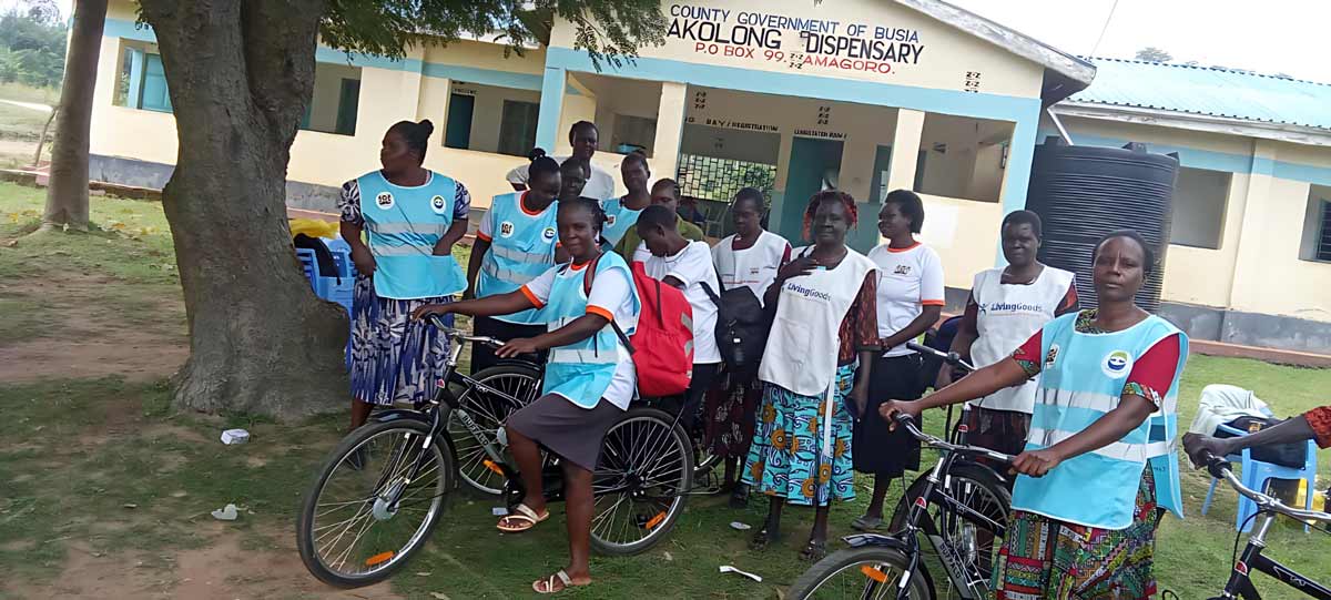Community health promoter Ms Linet Opili (left bike) and colleagues pose for a photo at Akolong Dispensary in Busia, Kenya. Credit: Angeline Anyango.