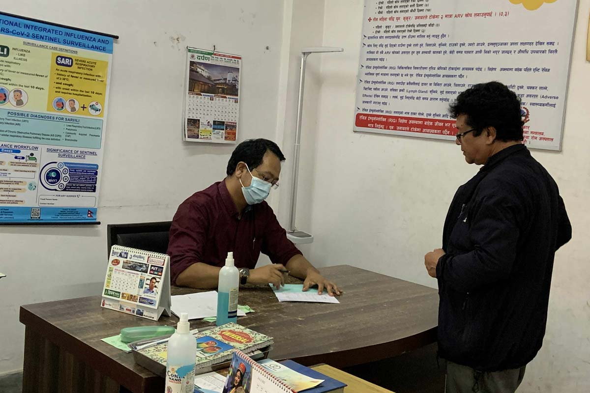Dr. Sher Bahadur Pun attending to a patient bitten by a dog. Credit: Pragya Timsina